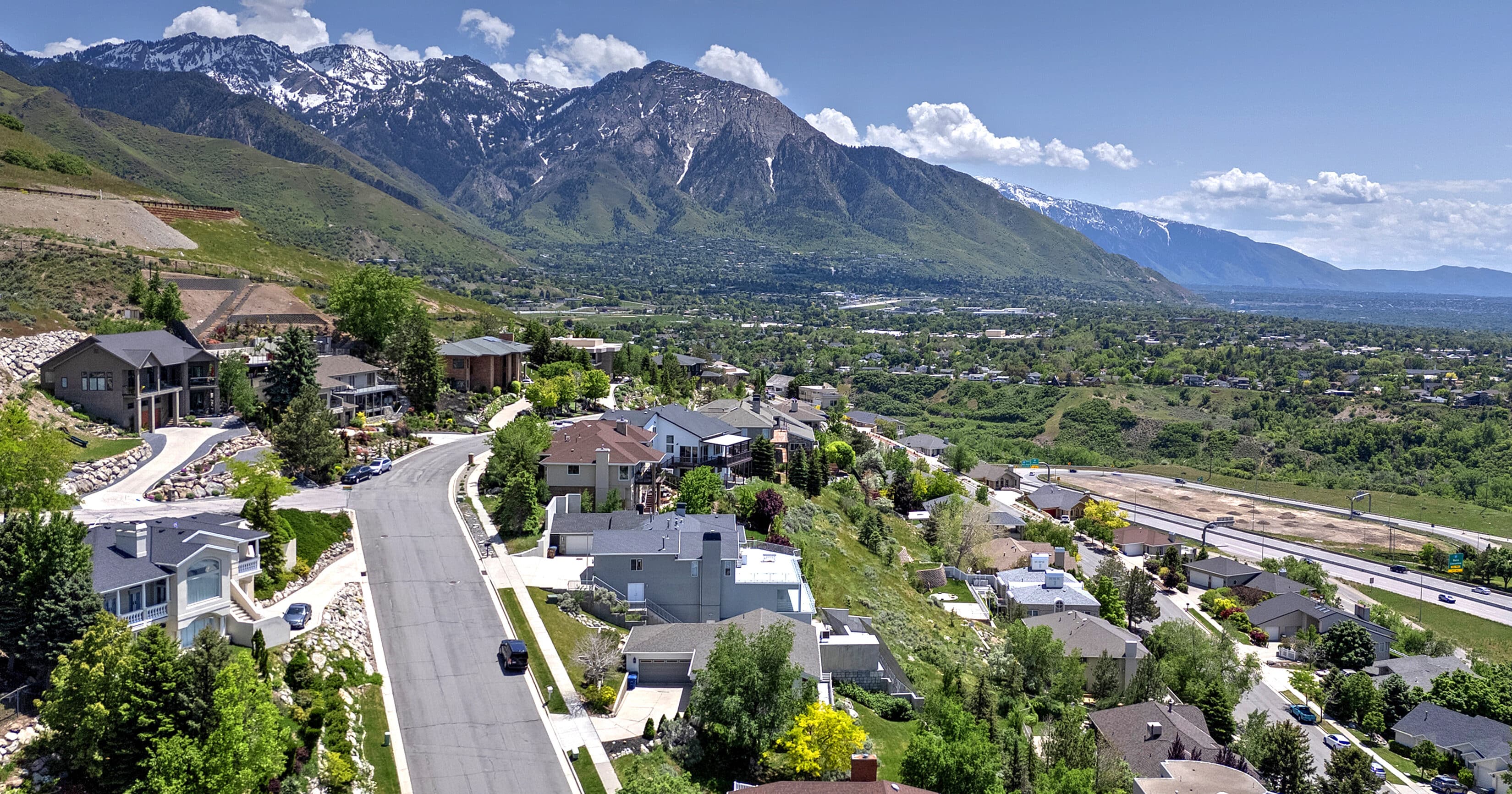 Single-family homes in Salt Lake City with mountains in the background on a sunny summer day